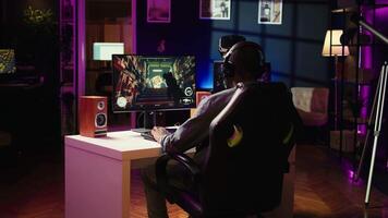 Gamer feeling annoyed after losing online multiplayer action videogame match, being outsmarted by rival players. Dejected man hitting desk after seeing game over message on computer screen, camera B video