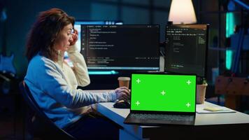 Admin using green screen laptop to implement security measures, protecting company systems and data. IT worker testing and debugging code for software applications on chroma key notebook, camera A video