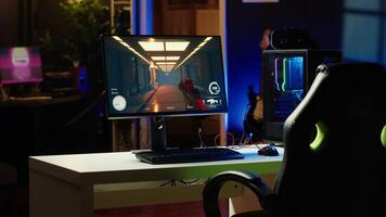 Stylish empty apartment with neon lights and computer screen left open at night showing videogame UI interface. Home living room with no people in and PC display left open video