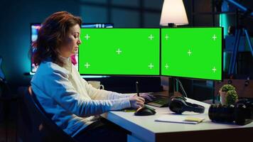 Content specialist uses graphic tablet to make social media post on isolated screen multi monitor setup for advertising company. Photo editor using mockup PC to create promotional image, camera A video