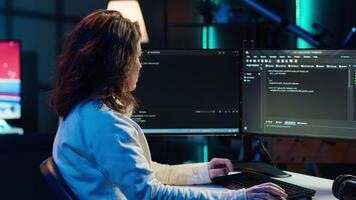 Teleworking system administrator futureproofing company network from downtimes and unexpected failures. Remote IT employee typing on keyboard, increasing data security, camera A video