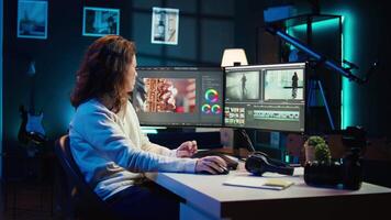 Upbeat videographer reviewing footage and selecting scenes, trimming using specialized software applications and editing tools. Smiling editor working for media company in editing room, camera B video