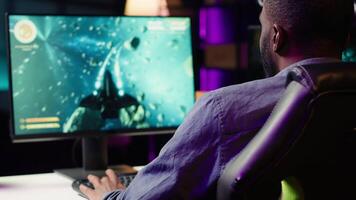 Player at home shooting asteroids in spaceship flying singleplayer game with overlay HUD showing health levels on monitor. Close up of person navigating universe in simulation game on PC video