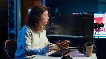 Tired woman hurting from too much stress accumulated while doing software quality assurance on computer. Developer suffers from headache after inspecting coding on PC for too long, camera A video