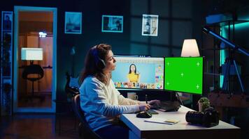Photographer wearing headphones using advanced photo editing software on green screen monitor to upgrade images. Photo editor utilizing photographs retouching application on mockup PC, camera B video