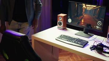 Cheerful streamer discussing with fans, showing them how to win computer game. Pro player starting stream, filming himself while playing on gaming PC, welcoming audience, camera B video