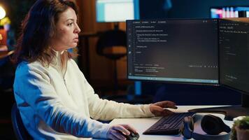 Cybersecurity expert looking confused at computer screen while trying to fix company security vulnerabilities. Contemplative developer feeling worried about potential cyberattacks, camera A video