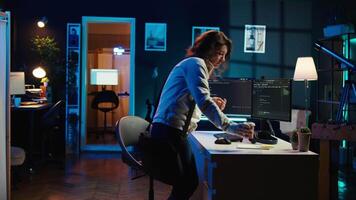 Developer holding disposable cup of coffee entering office to implement security measures, protecting company systems and data. IT worker starting job shift, testing and debugging code, camera B video