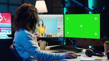 Content specialist uses graphic design skills to make social media post on green screen computer for advertising company. Photo editor using chroma key PC monitor to create promotional image, camera A video
