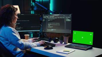 Programmer using green screen laptop to secure company servers from virus attacks. IT remote employee writing code, building firewalls protecting data using mockup notebook, camera B video