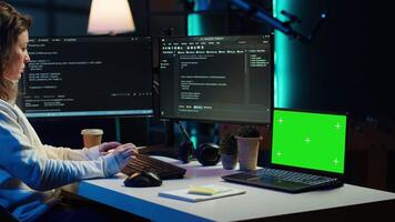 Programmer using green screen laptop to secure company servers from virus attacks. IT remote employee writing code, building firewalls protecting data using mockup notebook, camera A video