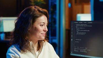 Delighted programmer celebrating after filtering malicious traffic from cybercriminals attempting to steal company data. Woman excited about accomplishment, preventing malware, camera A video