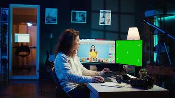 Content specialist uses graphic design skills to make social media post on green screen computer for advertising company. Photo editor using chroma key PC monitor to create promotional image, camera B video