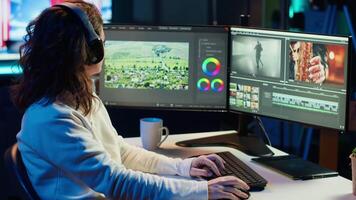 editor polishing raw footage, applying modern editing techniques in order to enhance sound and visual quality. Videographer adjusting clips while listening music in headphones, camera A video