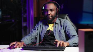 Gamer feeling relieved after winning videogame level, screaming at computer in excitement. Pleased man at home yelling from joy after seeing achieving victory while playing on gaming PC, camera A video
