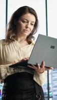 Vertical Female CEO leader working on financial planning and budget allocation, ensuring the company resources are used effectively to achieve maximum profit and long term objectives in office. Camera A. video