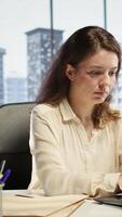 Vertical Portrait of powerful woman CEO working in a modern corporate office, managing daily business operations, optimizing workflow and ensuring the company meets its performance targets. Camera B. video