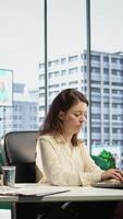 Vertical Enterprise director authorizing all work contracts and documents, signing paperwork as CEO with executive power. Solving all her legal obligations in high end office, leadership skills. Camera B. video
