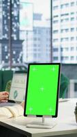 Vertical Young business manager working with isolated copy space on her tablet, working on financial planning with data analytics on laptop. Developing a strategy to increase funding for success. Camera A. video