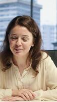 Vertical Empowered businesswoman sharing her goals and targets for the enterprise activity, discussing with investors on videoconference about a potential loan. Executive power from shareholders. Camera A. video