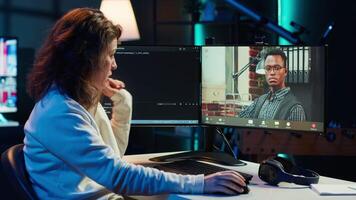 Woman doing software debugging helped by coworker in videocall, checking errors in lines of code. Programmer working from home fixing coding mistakes, assisted by colleague in teleconference, camera A video