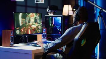 Gamer celebrating winning online multiplayer science fiction videogame tournament, pumping fists in air. Man feeling pleased about gaming championship victory on computer, camera A video