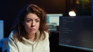 IT engineer fixing vulnerabilities in software enabling hackers to compromise operating system. Cybersecurity professional in apartment using computer to patch security exposures, camera A video