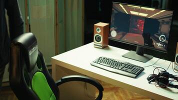 Professional gamer with headset on competing in online multiplayer videogame, streaming live from apartment. Streamer playing on PC, using headphones to talk with audience, camera B video