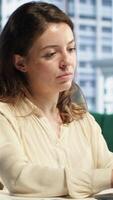 Vertical Powerful woman director receives project updates via text messages, discussing with the employees on the online corporation network. Female leader CEO with strategic thinking. Camera A. video