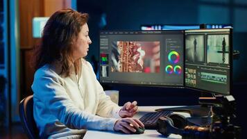 Portrait of happy editor merging raw clips and footage into high quality finished videos in production studio. Videographer using specialized software application and editing tools, camera A