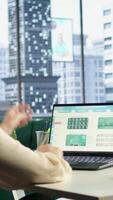 Vertical Young CEO searching for an investment solution and the right offer, avoiding trading risks and using funds to increase company profit. Female director planning finances in high end office. Camera A. video