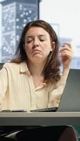 Vertical Enterprise director enjoys working with music on her headphones, solving business tasks at her high end office. Successful empowered woman CEO having fun with songs, work ethic. Camera A. video