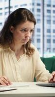 Vertical Female leader with executive power signing work contracts and approving employees requests, daily paperwork tasks for productivity. Authorization for leave request or license agreement. Camera A. video