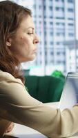 Vertical Powerful female director developing corporate innovation plan, exploring new possibilities and business models to enhance the enterprise advantage. Evaluating reports and data analytics. Camera A. video