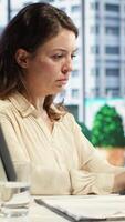 Vertical Young overburdened CEO dealing with a headache and working under pressure, trying to meet deadline and save her company reputation. Frustrated stressed director with discomfort. Camera A. video