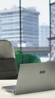 Vertical Empty modern corporate high end office space designed for a leader or person with authority, running analytics and reports on screen. Urban global enterprise workspace, empowerment. video