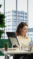 Vertical Confident female leader driven by empowerment and ambition, focuses on achieving business targets and enhancing company performance in a dynamic office setting. Leadership success story. Camera B. video