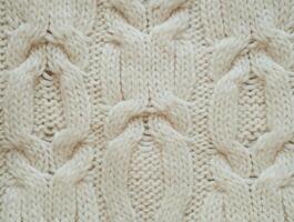 Close-up of the texture of knitted woolen fabric in milky color photo