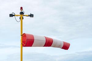 windsock is a conical textile tube that used as an indicator of wind speed and direction photo