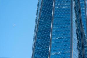 modern architecture, glass facade element of skyscraper against evening sky photo