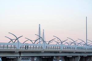 urban background with a fragment of a high-speed automobile overpass on the background of a bridge photo
