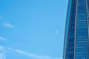 modern architecture, glass facade element of skyscraper against evening sky photo