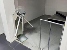 Entrance with turntables. A checkpoint with a turnstile. Turnstile with card reader. Electronic checkpoint. We pass on the territory. Incoming people control. Subway entrance. photo