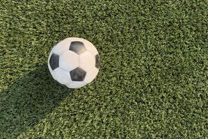 top view of football on green field, soccer ball on grass photo