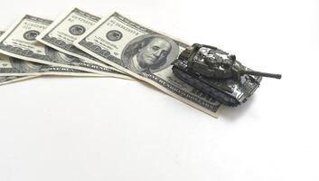 toy tank on the background of dollar bills photo