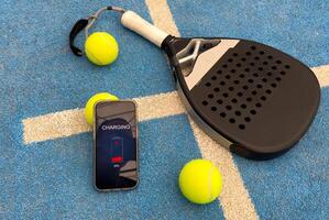 paddel racket and smartphone with bet background photo