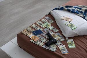 wallet with money out of a murder evidence bag, conceptual image photo
