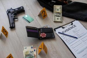 High contrast image of a crime scene with gun and markers on the floor photo
