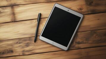 A sleek tablet rests on a wooden surface beside a stylish pen photo