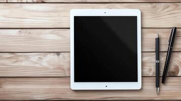 A sleek tablet rests on a wooden surface beside a stylish pen photo